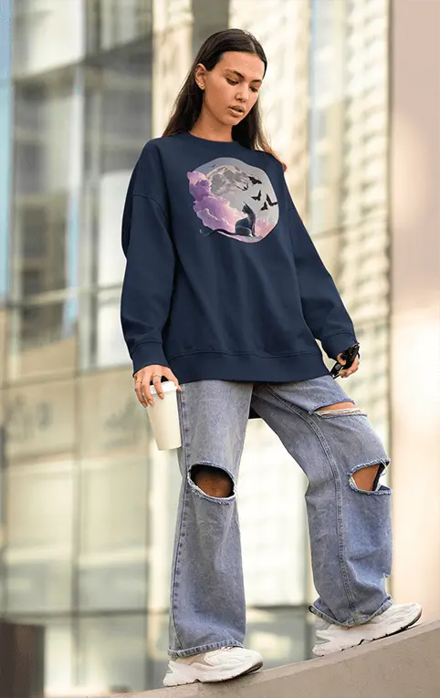 Crewneck Sweatshirt in Navy Blue with Dreamcore Cat Graphic on Model with Ripped Blue Jeans and White Sneakers